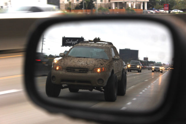 Lifted Subaru in rearview mirror - CRANKSHAFT CULTURE