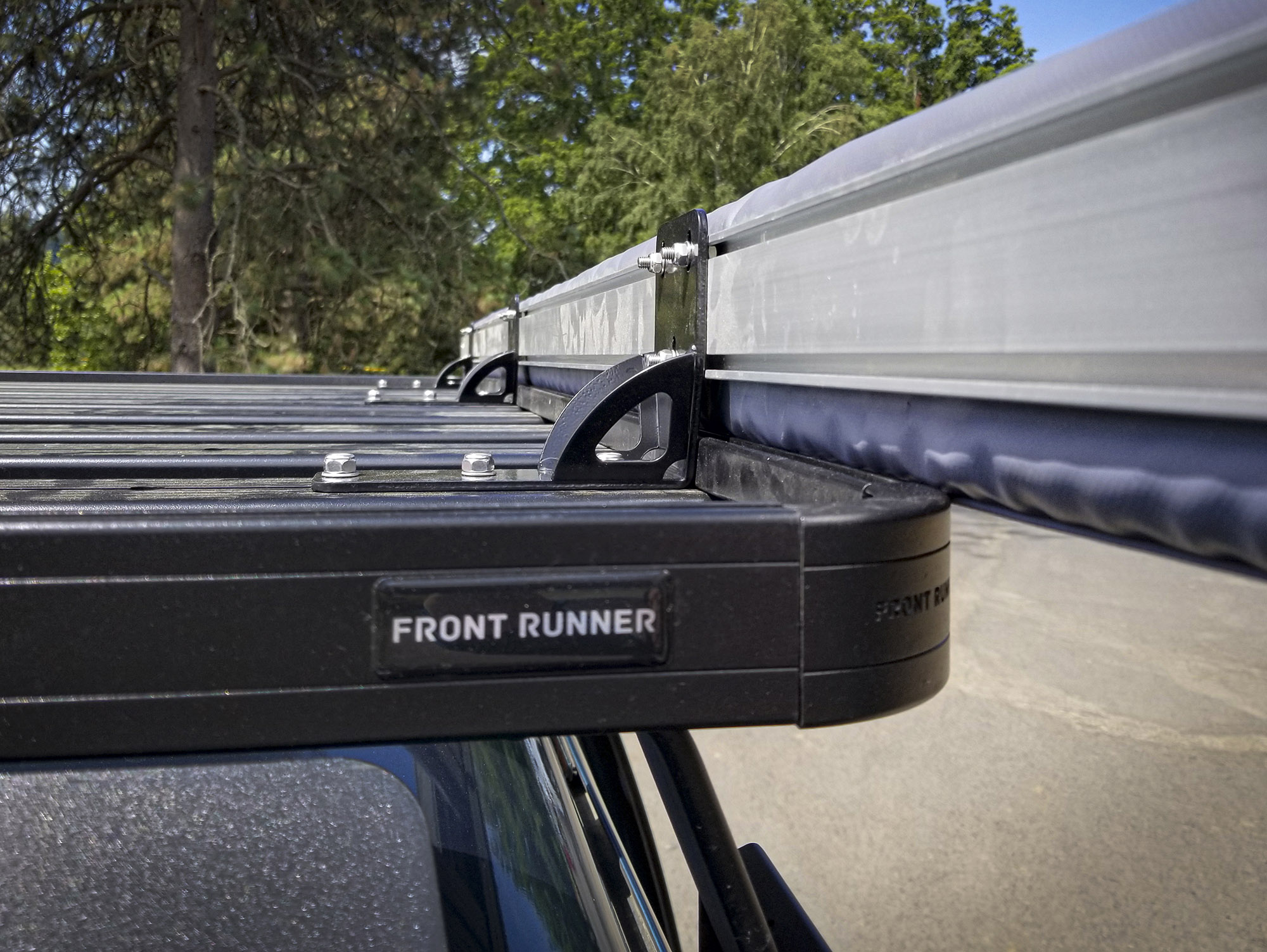 The black ARB Universal Awning Brackets fit perfectly on our black Front Runner Slimline II rack