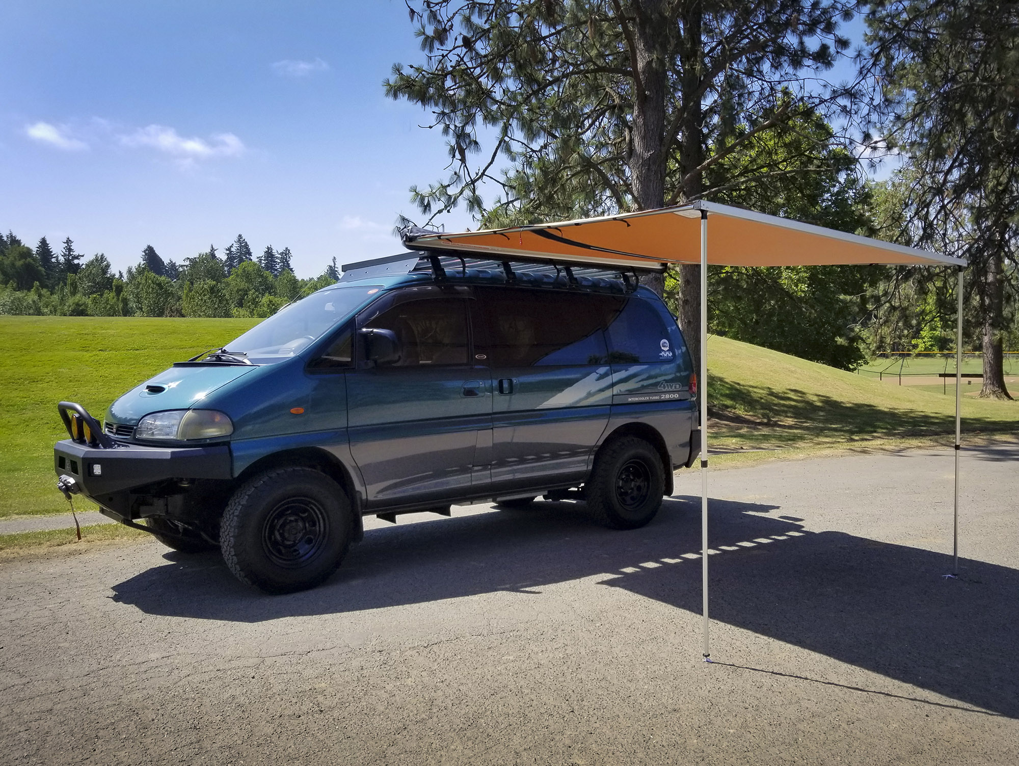 ARB814410 awning on teal Mitsubishi Delica Space Gear van