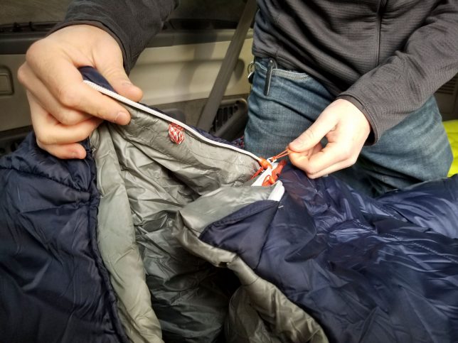 Andy is unzipping the Big Agnes Torchlite 20 men's sleeping bag