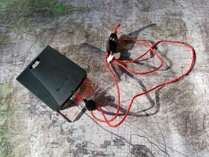 A Suunto global MC-2G compass is sitting on a topographic map