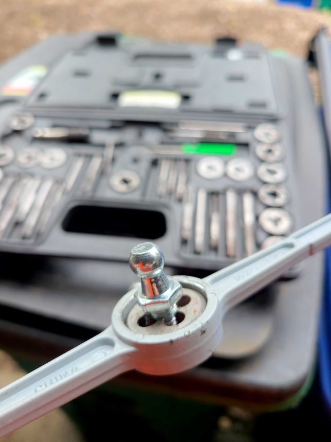 Using a die to rethread the ball stud. 