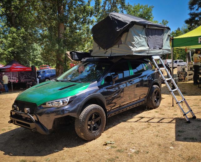 Lifted green Subaru Crosstrek with rooftop tent at Big Northwest Meet 2023
