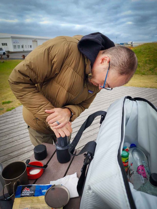 Making coffee in Icelanding using an AeroPress Go with an AO Coolers Carbon Series on the table. 