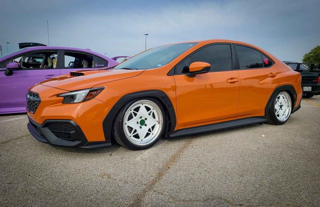 2022 Subaru WRX  in orange with white wheels at Subiefest Texas 2023.