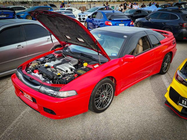 Clean red Subaru SVX at Subiefest Texas 2023.