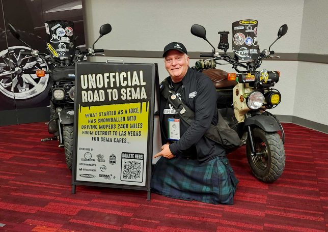 Greg Henderson at the SEMA Show with the two Honda Ruckus scooters.