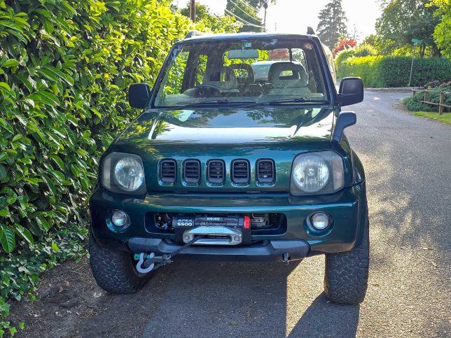 The front of a 1998 Suzuki Jimny Wide with a winch.,