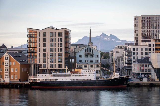 View of a ferry boat of a city and mountains