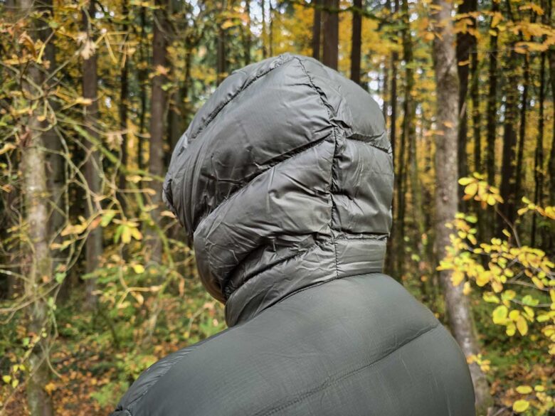 Man wearing Cotopaxi Fuego Max down jacket, hood detail