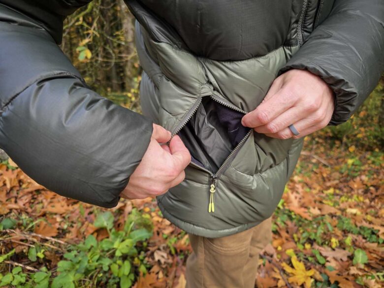 man wearing Cotopaxi Fuego Max down jacket, zippered hand pockets