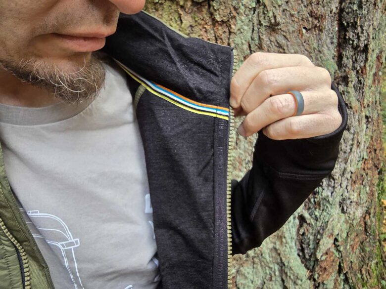 Man wearing Smartwool Smartloft Hybrid Jacket interior zipper detail
