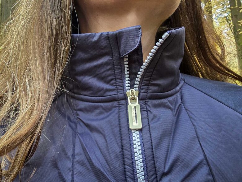 Woman wearing Smartwool Smartloft Hybrid Jacket front zipper detail
