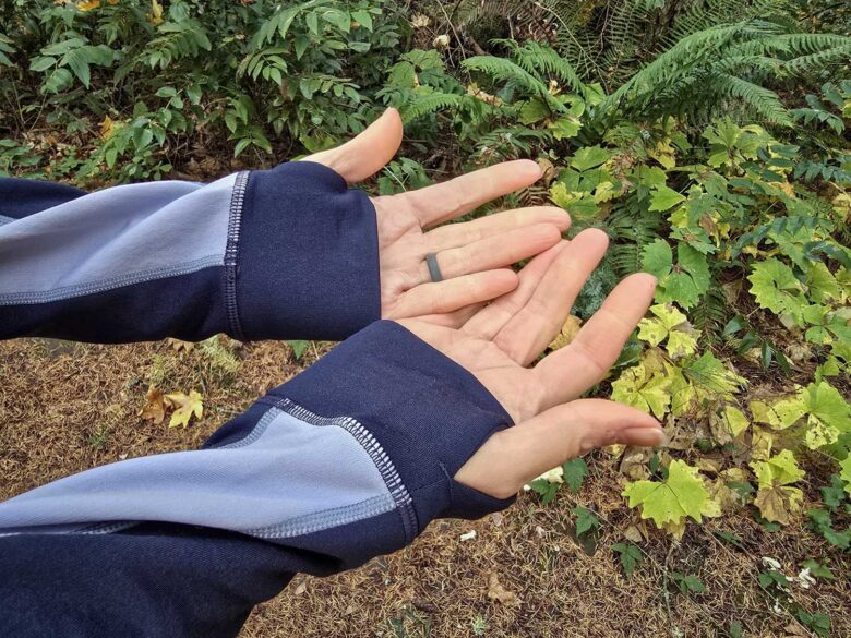 Woman wearing Smartwool Smartloft Hybrid Jacket thumb holes