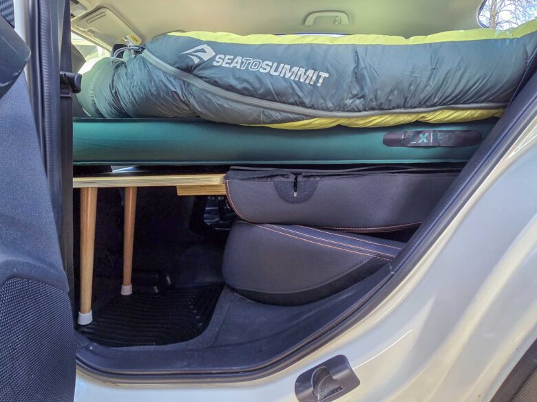 Women's specific and Unisex Sea to Summit Ascent Down Sleeping Bags laying on Sleep Rides sleeping platform in car