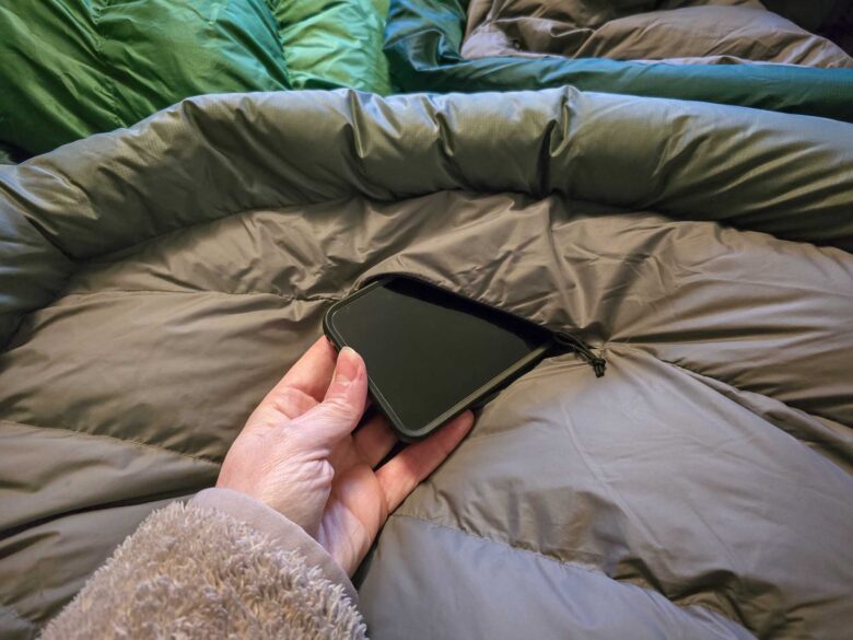 Unisex Sea to Summit Ascent Down Sleeping Bag's internal zipper pocket detail with smartphone