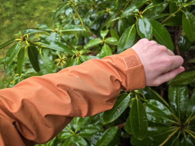 Cotopaxi Impermeo 3L Hooded Shell Jacket and water beading on sleeve