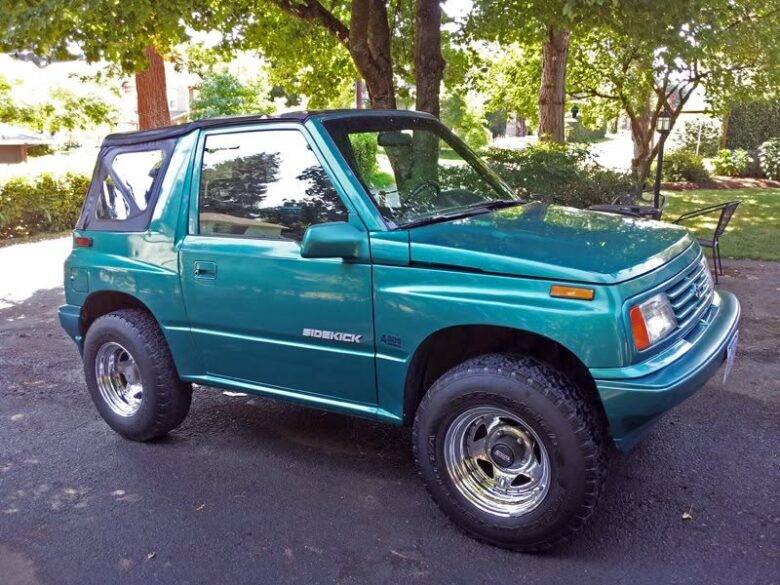 1995 Suzuki Sidekick on 15x8 chrome wheels and very old BFGoodrich tires.